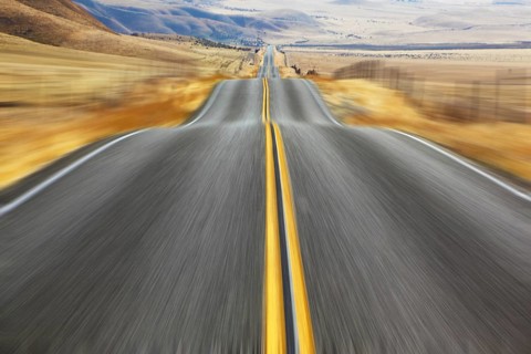 A Mirage on high speed. Magnificent American road and fencings on roadsides from snow drifts