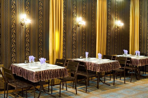 Served tables in a cafe, black and golden hues