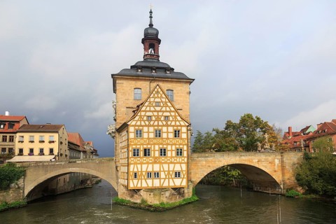 Obere bridge (brücke) and Altes Rathaus and cloudy sky in Bamberg, Germany