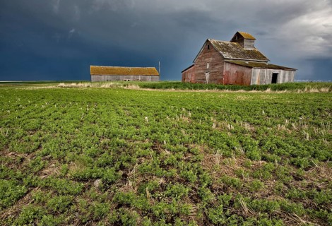 Abandoned Farm with storm clouds in the Canadian Prairie
