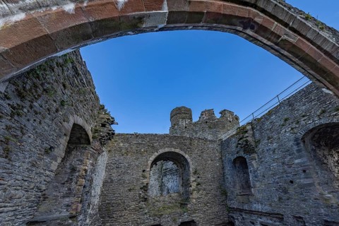 Conwy Castle, ruined stone walls and arch of the castle with a view of the sky, Conwy, Wales, Great