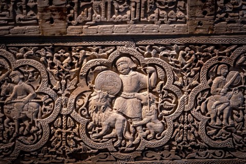 A man on foot, armed with a spear and buckler, rained down against two lionsn Spanish-Arab chest of