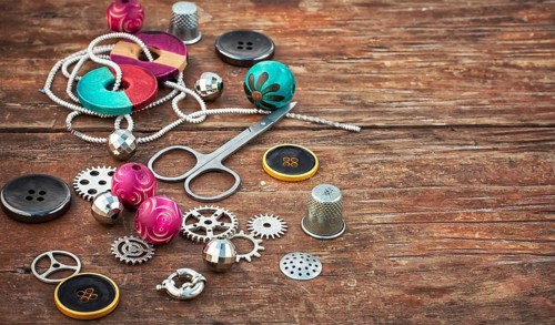 Beads and jewellery for handmade on light orange plate