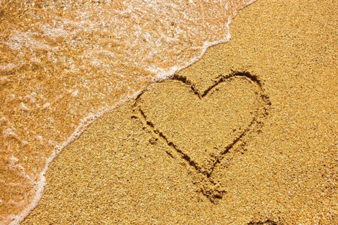 Heart symbol on the sand. Summer holiday concept. Romantic love background. Valentin Day theme. Top
