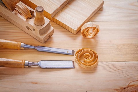 Woodworkers plane and carpentry chisels on wooden boards horizontal version
