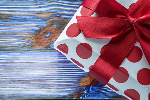 Red boxed birthday gift on vintage wooden board