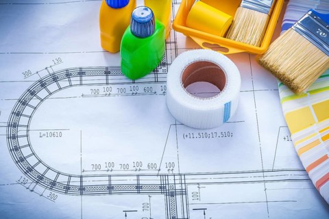 Construction drawing with paint brush roller tray bottles duct tape and color sampler maintenance