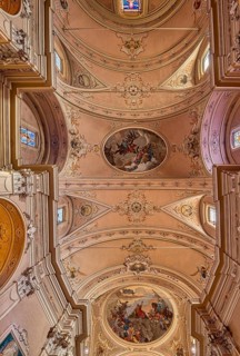 Stucco ceiling with frescoes in the catholic church of Santo Stefano