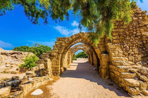 Sunny spring day. Arched passage - covered street. Picturesque ruins of the ancient seaport