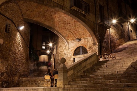 Arch of the Agullana Palace and Sant Domenec stairs at night in Girona, Catalonia, Spain