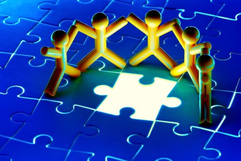Team work on solving puzzle problem. Team work concept.