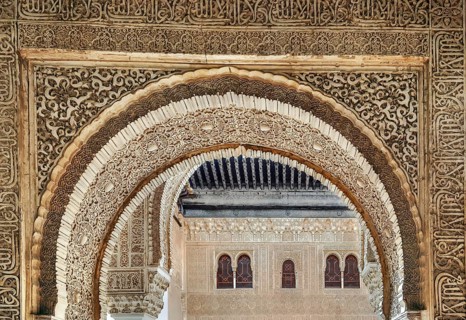Arch with stone relief with arabesques in Alhambra palace, Spain