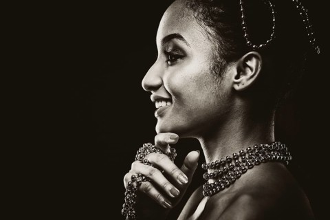 Upscale Indian woman wearing chain jewellery and beautiful makeup. Black and white photo.