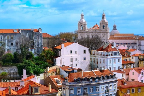 Lisbon, Portugal panoramic aerial view with colorful houses and Estrela Basilica cathedral towers
