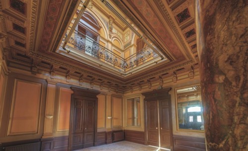 Magnificent staircase with ceiling fresco, framed by columns and elegant wooden doors, Villa