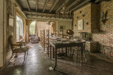 A dining room in an abandoned state, with an empty table and scattered chairs, Maison Limmi, Lost