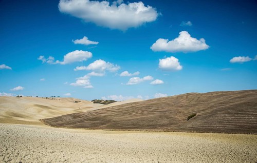 Beautiful idyllic farmland with meadow field at Tuscany area near Pienza touristic village, Italy