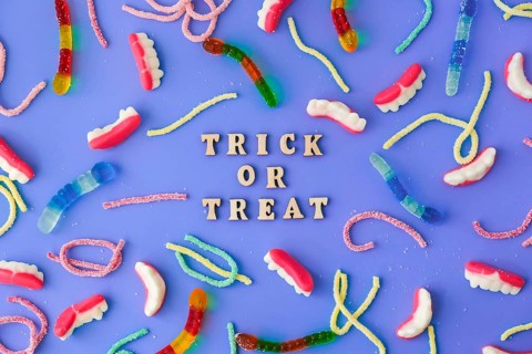 Halloween concept. Halloween party decorations with words TRICK OR TREAT, sweets, top view flat lay