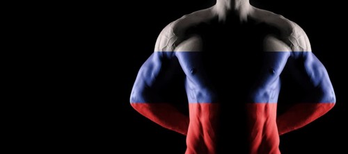 Russia flag on muscled male torso with abs, black background