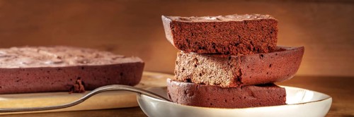 Chocolate brownie panorama, simple coffee cake, a side view shot on a dark rustic wooden