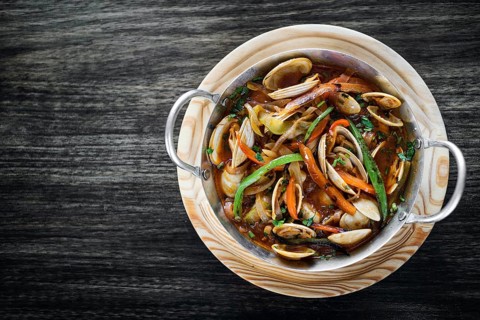Gourmet portuguese clam and vegetable seafood stew in spicy tomato sauce