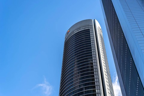 Madrid, Spain, May 10, 2020: Low angle view of office building in the city of Madrid against blue