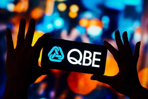 In this photo illustration, the QBE Insurance Group logo is displayed on a smartphone mobile screen