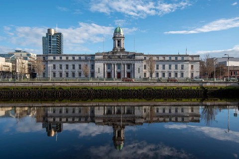 Cork city hall building reflected on river lee. Ireland Europe