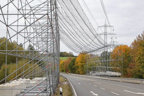 A scaffold with steel net as protection over a road, safety measure due to work on an overhead line