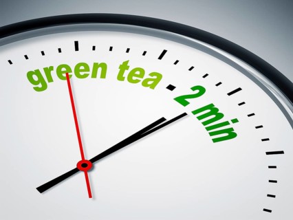 An image of a nice clock with green tea - 2 min