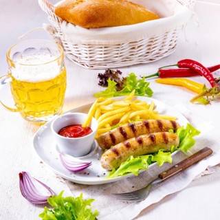 Grilled bratwurst with chips and cold beer