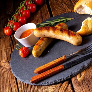 Rustic bratwurst with ketchup and fresh rolls