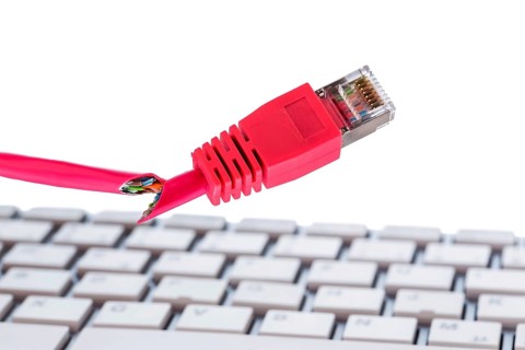 Defective network cable on keyboard, symbol photo for online, networks, malfunction and espionage