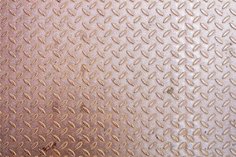 An image of a rusty diamond metal plate background