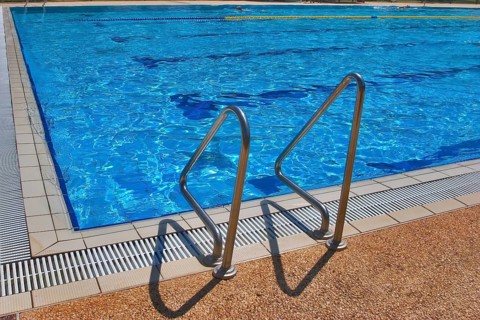 Pool with pure transparent water and hand-rail of descent