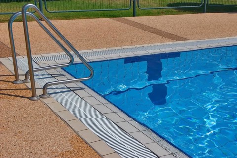 Pool with pure transparent water and hand-rail of descent