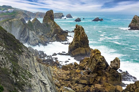 Noon on the beach of Playa di Arnia, Spain. Cantabria. Windy stormy day on the Atlantic coast.