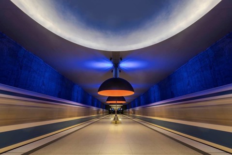 Futuristic underground railway tunnel with blue and yellow lighting, Munich, Bavaria, Germany