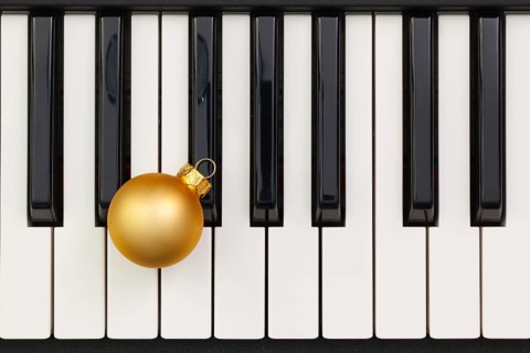 Top view close up shot of piano keyboard and Christmas decoration. Flat Lay Image