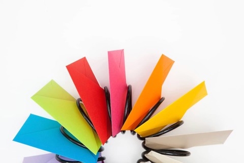 Propeller of colored envelopes on the white table