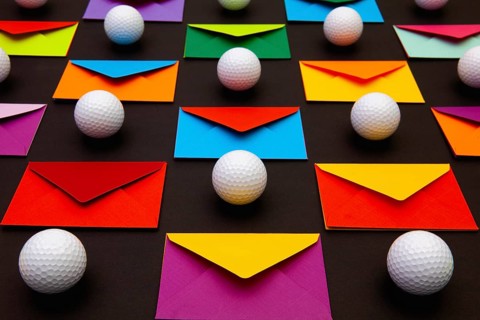 Composition with colored envelopes and golf balls on the table. The photo suitable for various