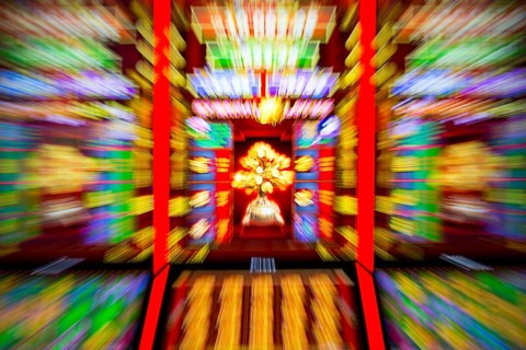 Slot machines in casino equipment exhibition. Zoom out effect