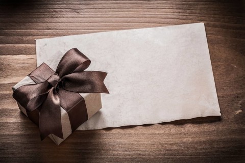 Giftbox paper on vintage wood board holiday concept