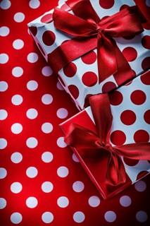 Christmas presents on polka-dot red textile holidays concept