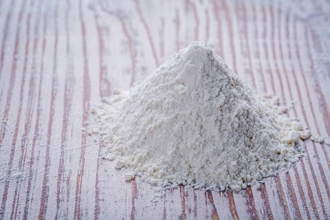 White flour on wooden board food and drink concept