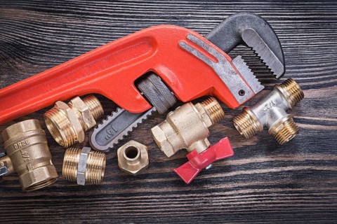 Set of plumbing tools on wooden board horizontal view