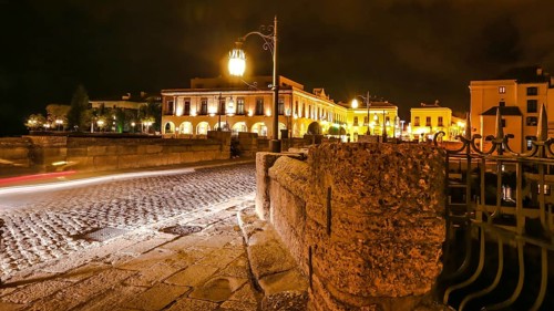 Night time on the historic landmark New Bridge Puente Nuevo of Ronda town in Spain. with running