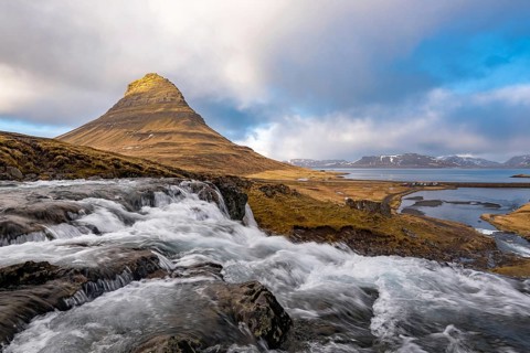 The Kirkjufell mountain and the kirkjufellfoss waterfall at grundarfjordur at Snæfellsnes peninsula