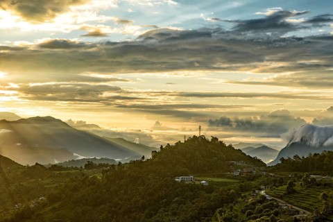 Mountains under the light of sunrise through clouds