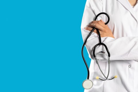 Lady doctor with arms folded and a stethoscope around her neck